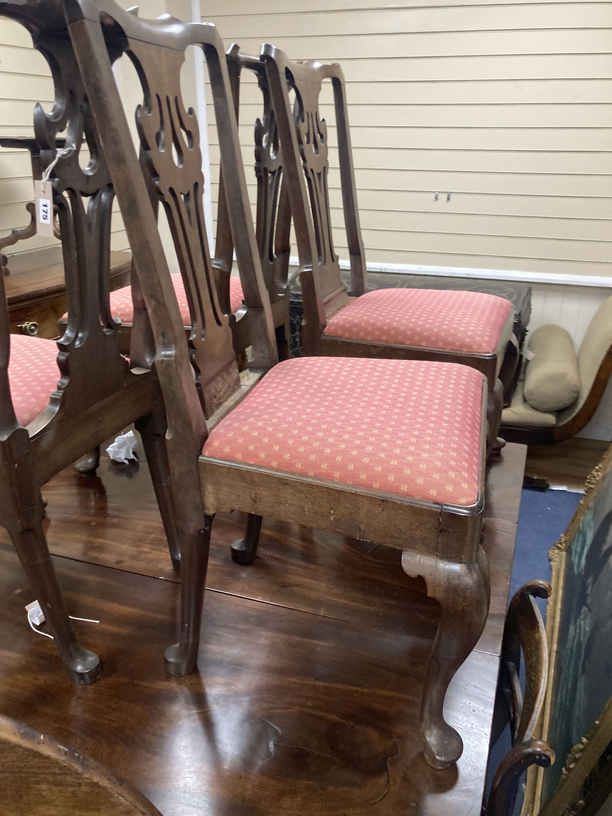 A set of four mid-18th century walnut / mahogany dining chairs